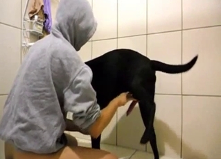 Babe is sucking her doggy in the bathroom